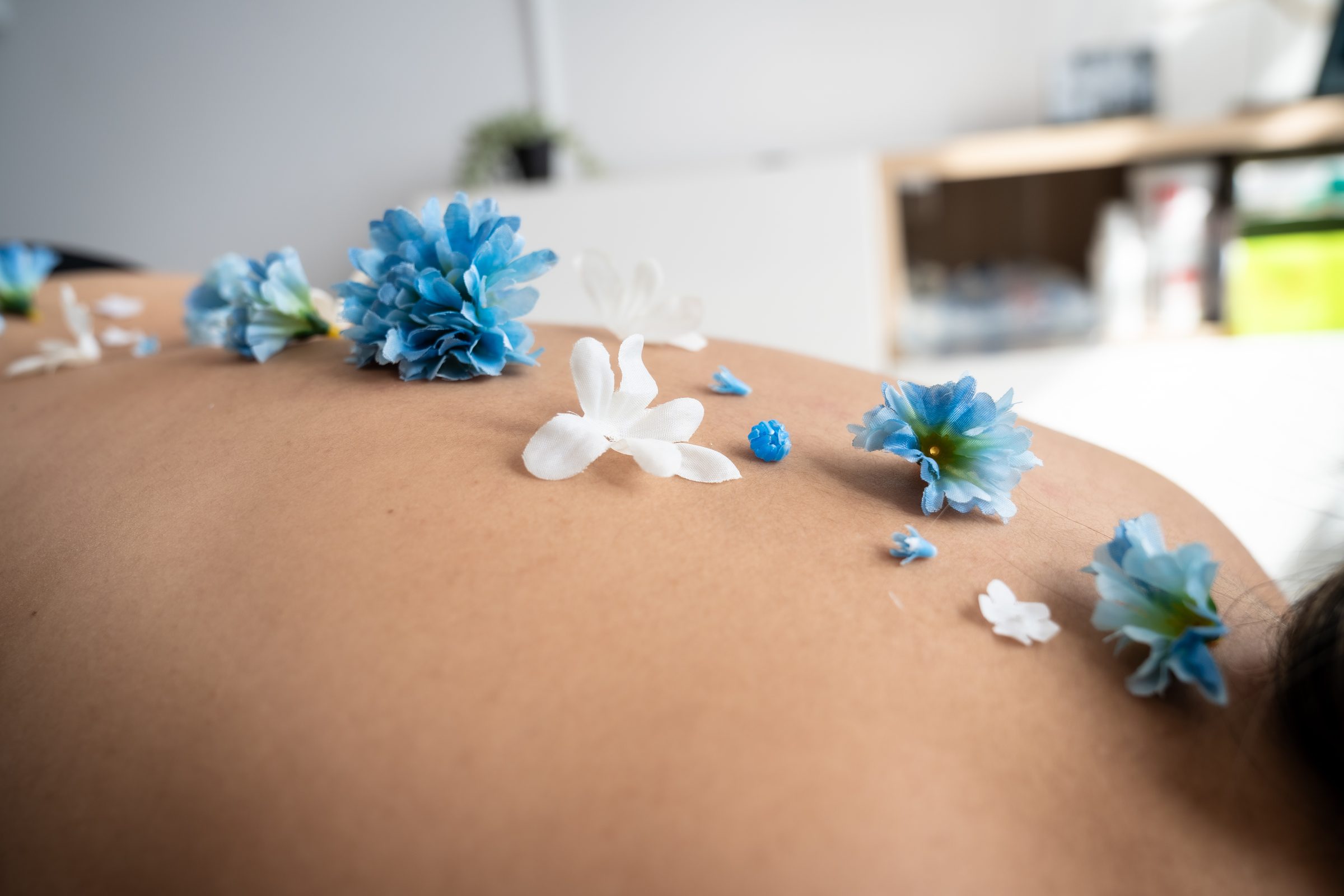Flowers laid along a back, at the flō clinic