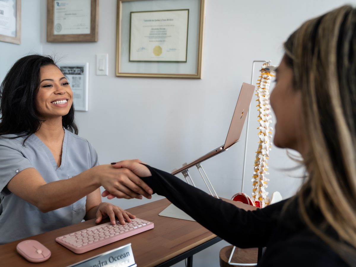 Dr. Alexandra Occean welcoming a patient at her desk